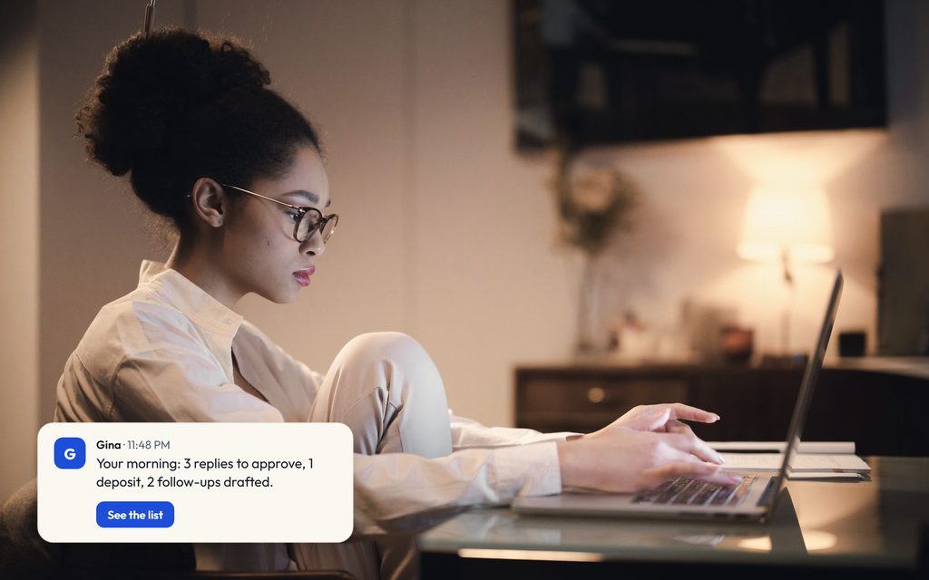 Owner working at a laptop by lamplight late at night, with a Gina message laying out the list for the morning.