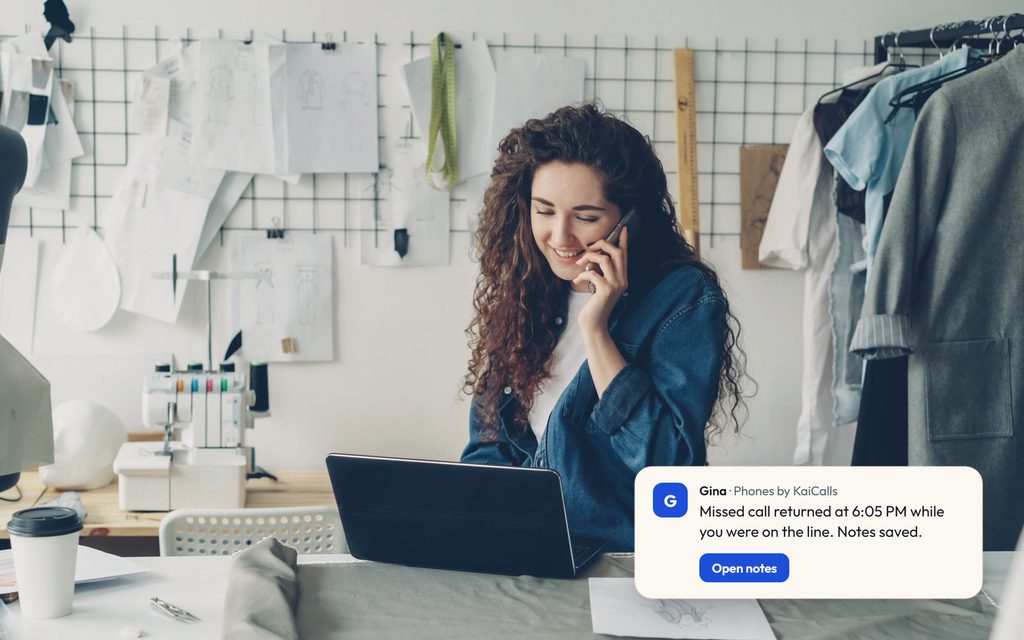 Designer on a phone call at a laptop in a studio, with a Gina message saying a missed call was returned and notes were saved.